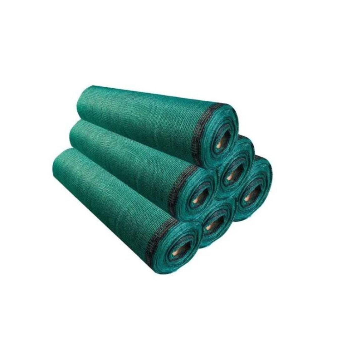 Rolls of green building material neatly stacked, available at a building material shop in Qatar, suitable for construction and landscaping.