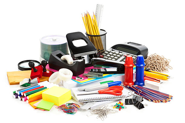 A diverse collection of office stationery items, including pencils, calculators, clips, and more, ideal for any office stationery supplier in Qatar. The image features a variety of items scattered on a white background:</p>
<p>Pencils held in a wire mesh cup<br />
Calculators<br />
Adhesive tapes and tape dispensers<br />
Colorful markers and highlighters<br />
Paper clips, binder clips, and rubber bands<br />
Notepads and sticky notes in various colors<br />
A pair of scissors with red handles<br />
This assortment represents the essentials for a well-stocked workplace